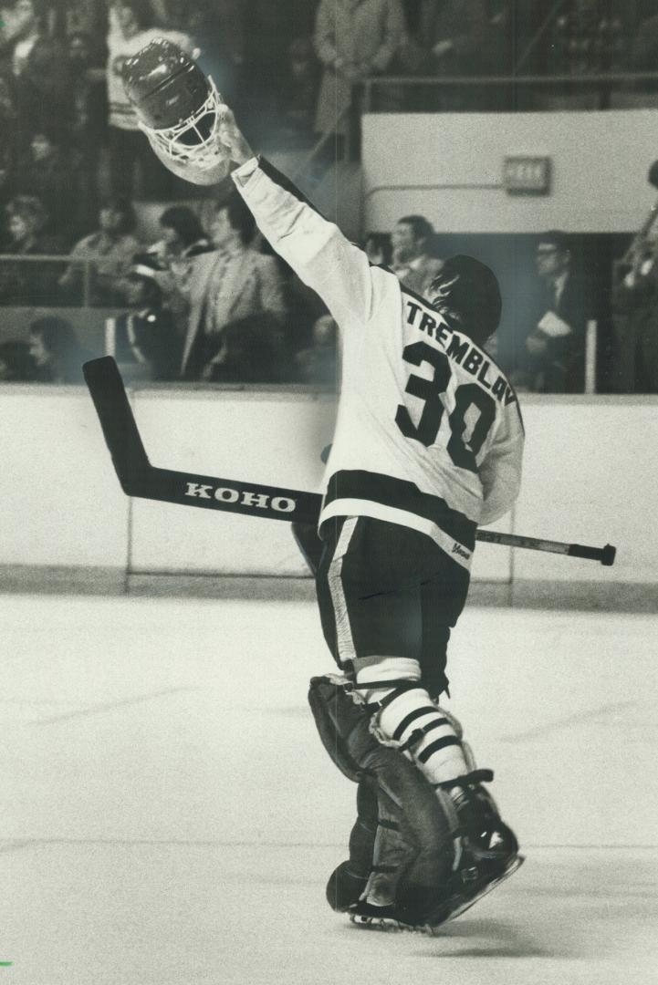 Ca va!: Toronto Maple Leafs' rookie goalkeeper Vince Tremblay waves his mask in the air in triumph after his first National Hockey League shutout last night against Philadelphia