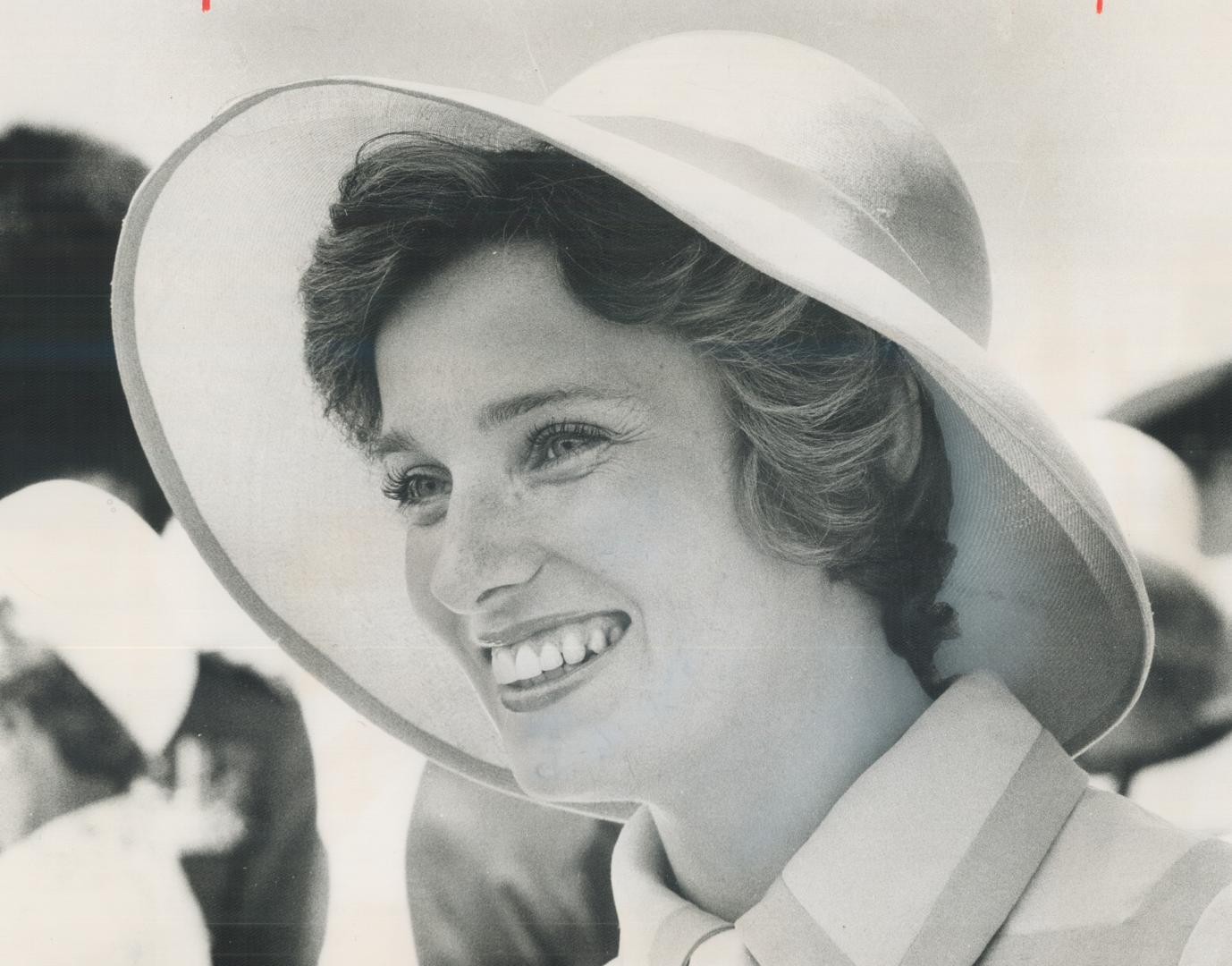 Margaret Trudeau, wife of the Prime Minister, wore orange silk to the airport to greet the Queen and Prince Philip