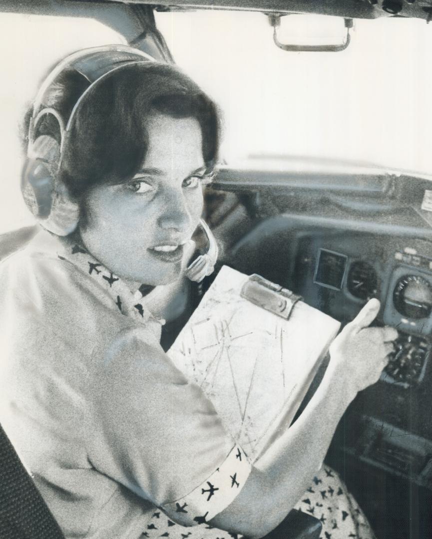 In command of Boeing 707 returning from Venezuela, Margaret Trudeau, the Prime Minister's wife, sits in the cockpit yesterday. The pilot, after briefi(...)