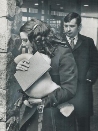 Margaret Trudeau holds baby Justin and a book as she returns to the Inn on the Park at Eglinton Ave