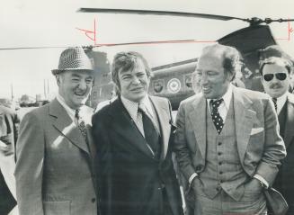 Prime Minister Pierre Trudeau and John Munro, his labor minister, arrive at Domnion Foundries and Steel in Hamilton for a tour of the plant