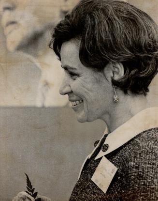 Eyes on her brother, Mrs. Pierre Rouleau, sister of Pierre Elliott Trudeau, watches as delegates at Liberal leadership convention cheer him on podium last night