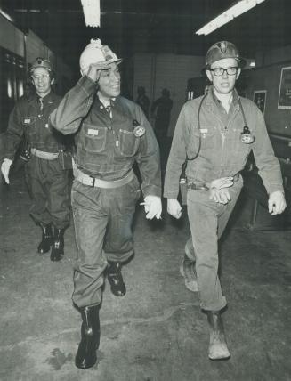 Going underground, Prime Minister Pierre Trudeau tips his hardhat as he tours Falconbridge Nickel Mines, near Sudbury