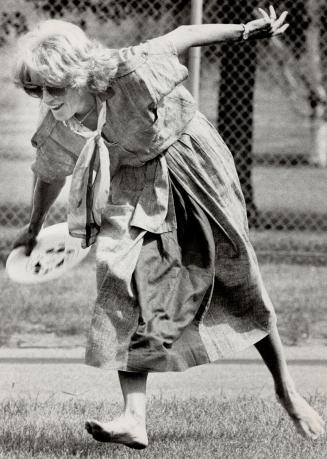 Geills Turner takes advantage of a brief refueling stop here to play catch with a frisby in her bare feet