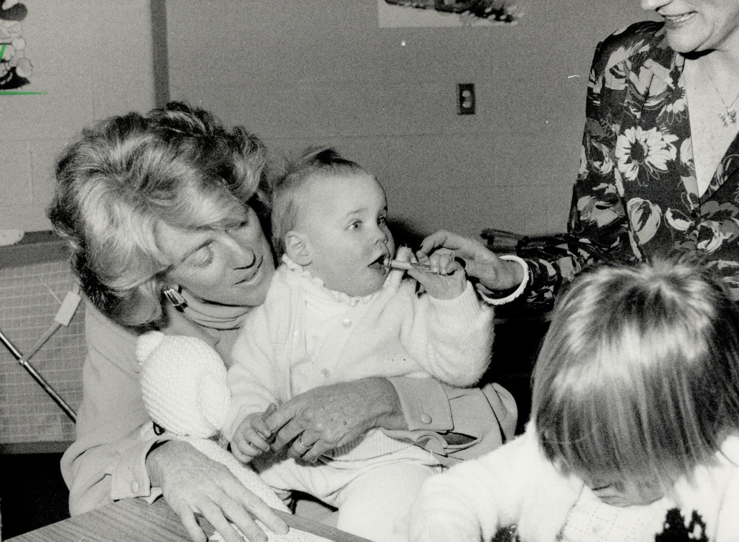 Little Jessie's appetite for a crayon was a bit too much yesterday for Geills Turner who toured the the Salvation Army family life centre in Toronto with her husband, Liberal leader John Turner