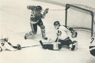 Not this time: Ex-Leaf captain Rick Vaive slaps at puck but is thwarted by goalie Ken Wregget last night