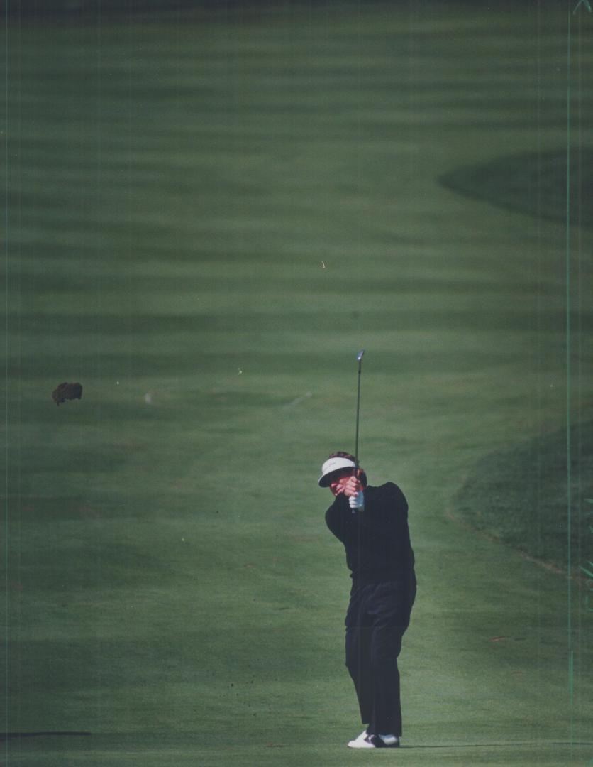 Wadkins on Target: Lanny Wadkins, getting his swing grooved on the plush expanse of Glen Abbey, follows through with an iron shot to the green in preparation for today's opening round