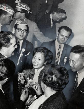 Enthusiastic supporters crowd around Ketchin Wang (right) and his wife or he won the Progressive Conser East last night