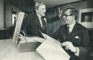 Jake Warren, seated, and Patrick Lavelle review notes for Warren's speech