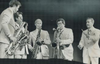 Televisions champagne music maker Lawrence Welk conducts his trombone players at successful conccert before 21,000 fans in the CNE Grandstand last night