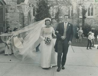 Bride and Groom, Mr. and Mrs. Peter Dalglish leave church followed by bridesmaids, Jana Weston, 3, Sarah Weston, 11 and Eliza Mitchell, 3, all nieces