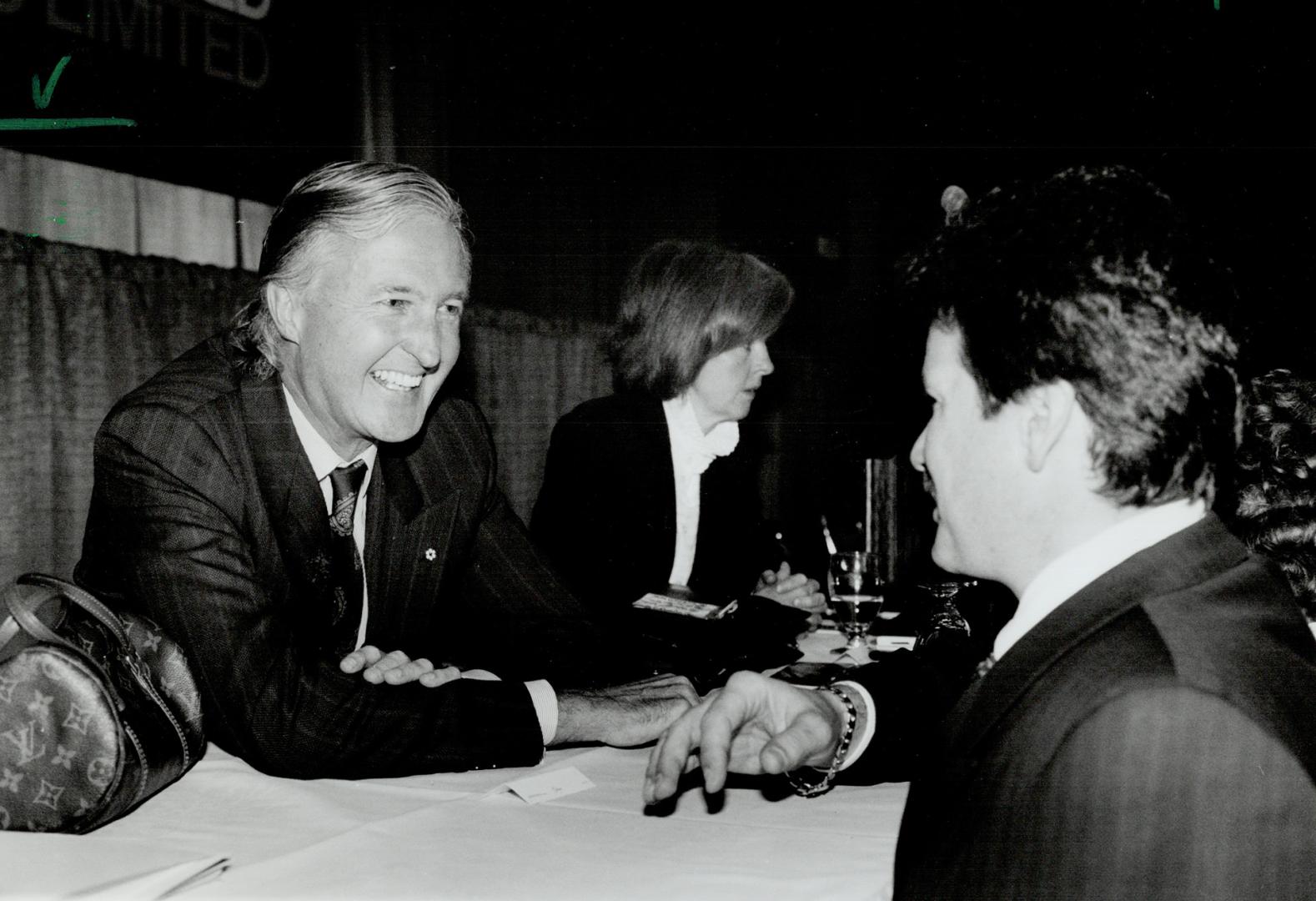 New approach: Loblaw Cos. chairman Galen Weston, left, chats after the annual meeting, where he outlined strategy for tough times