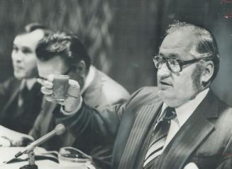 Eugene Whelan, Minister of Agriculture, raises a glass of tomato juice at today's cabinet meeting