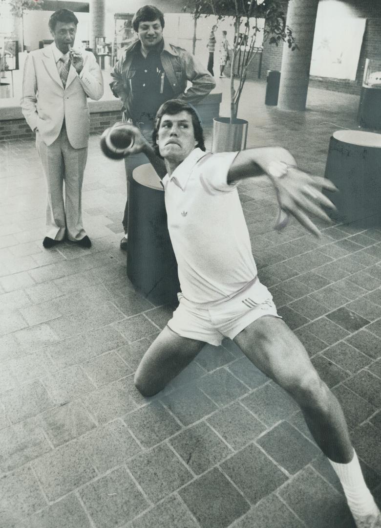 He throws, he misses . . . Al White, a Toronto Argo quarterback, threw a 75-yard bomb to North York Controller Bob Yuill in the new North York municipal building but it was too hot for Yuill to hold