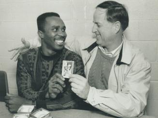 You're Mine!' Blue Jay general manager Pat Gillick, right, gives his new centre fielder Devon White a friendly hug during a card and autograph show yesterday at Exhibition place