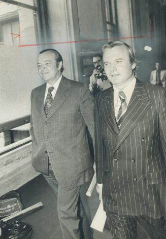 Provincial treasurer John White (left) and Premier William Davis walk to a meeting of Conservative MPPs today shortly before Davis announced that the (...)