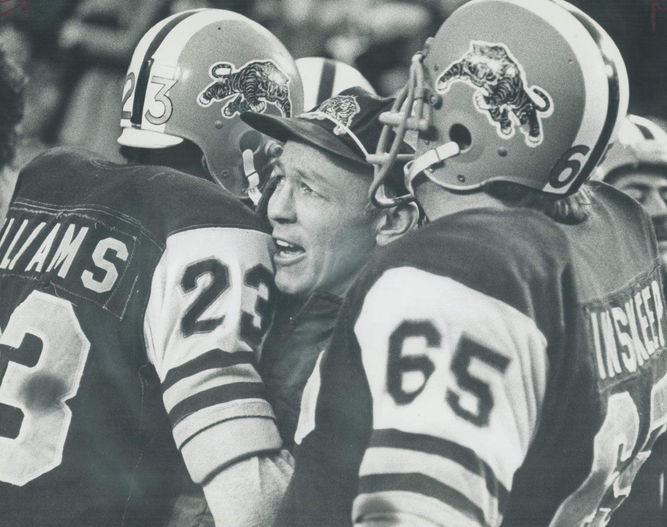 Happy threesome: Hamilton Tiger-Cats' coach Jerry Williams gets hugs from John Williams (left), Gary Inskeep in final seconds of Eastern Conference game at Hamilton yesterday