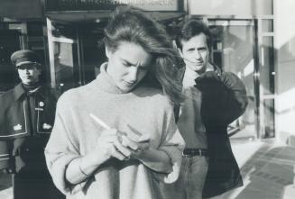 Katarina stars off ice. Katarina Witt signs an autograph yesterday while fellow skater Brian Boitano looks on. The two Olympic gold medtalists, on a 2(...)