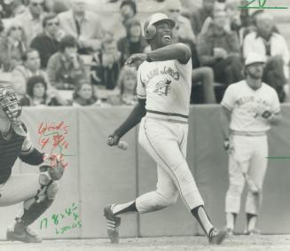 Look of satisfaction: Alvis Woods has a grin on his face as he collects a base hit during Blue Jays' 2-0 win over Tigers yesterday afternoon at Exhibition Stadium