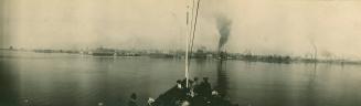 Image shows a number of people on the boat with the Harbour in the far background.