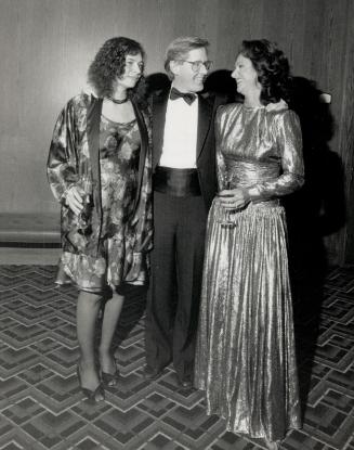 Far left, Arlene Perly Rae, in a short dress and matching jacket, gets a hug from husband and Ontario NDP leader Bob Rae while designer Brenda Muncaster looks on