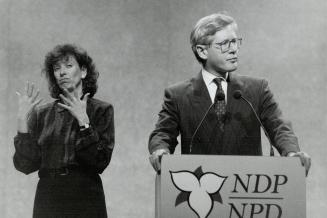 Signing on: Premier Bob Rae addresses NDP convention delegates while an interpreter translates in sign language