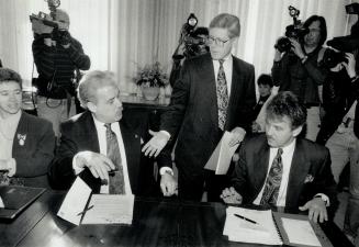 Helping hand: Premier Bob Rae assures Cornwall Mayor Ron Martell, left, and Windsor's Michael Hurst yesterday that he'll try to fight cross-border shopping