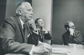 Housing minister Stanley Randall (at left in foreground) listens glumly as Mike Carson pounds a table and lists complaints about public housing projec(...)