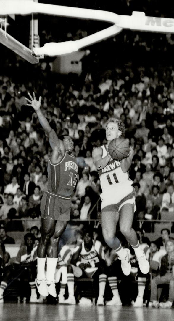 Toronto's Leo Rautins of Atlanta Hawks (11) leaps for the basket during NBA exhibition game at the Gardens last night as Vinnie Johnson of Detroit def(...)