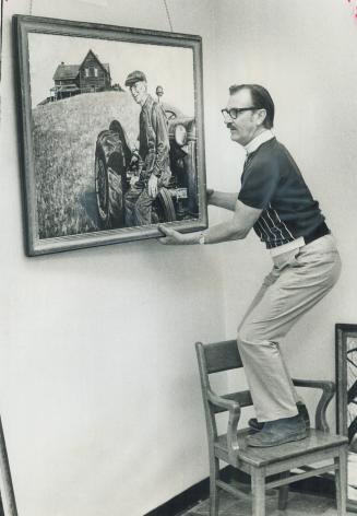 Gordon Rayner of Chinguacousy mounts a landscape, one of several paintings he has done of rural areas in Peel County