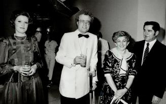 Toronto Mayor Art Eggleton, on crutches after a particularly energetic tennis game, is consoled by Olympia and York president Albert Reichmann and his(...)