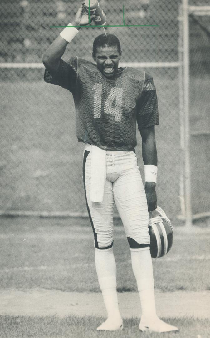 Hot quarterback: Gilbert Renfroe, who tossed the pass to Tony Johns that gave the Argos a nail-biting climactic win over Hamilton Tiger-Cats, cools off during a steamy practice yesterday