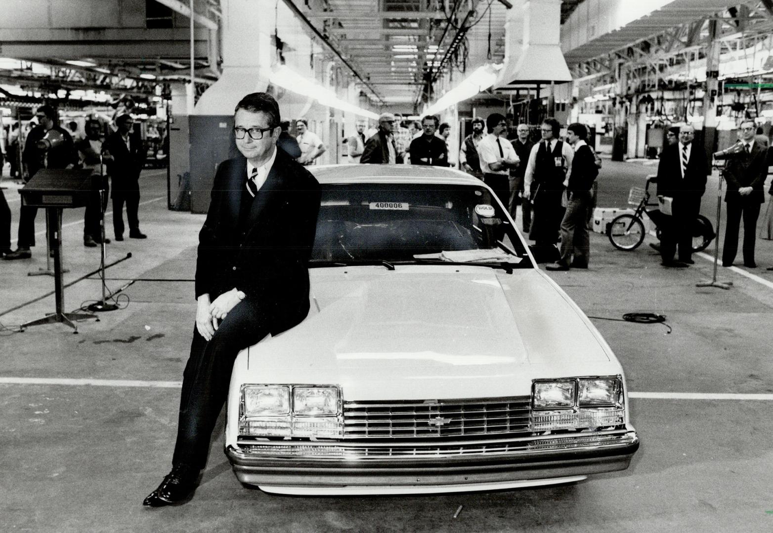 Retiring president: James Rinehart, who announced his resignation as GM Canada boss yesterday, sits on the hood of the first Canadian made A-Car to roll off the line last week