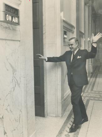 Premier John Robarts almost dances as he returns to Queen's Park