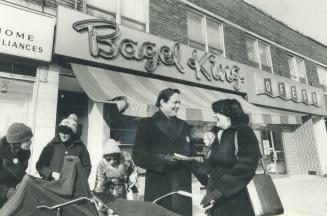 The contender: Liberal John Roberts shares a laugh outside bagel store on Eglinton