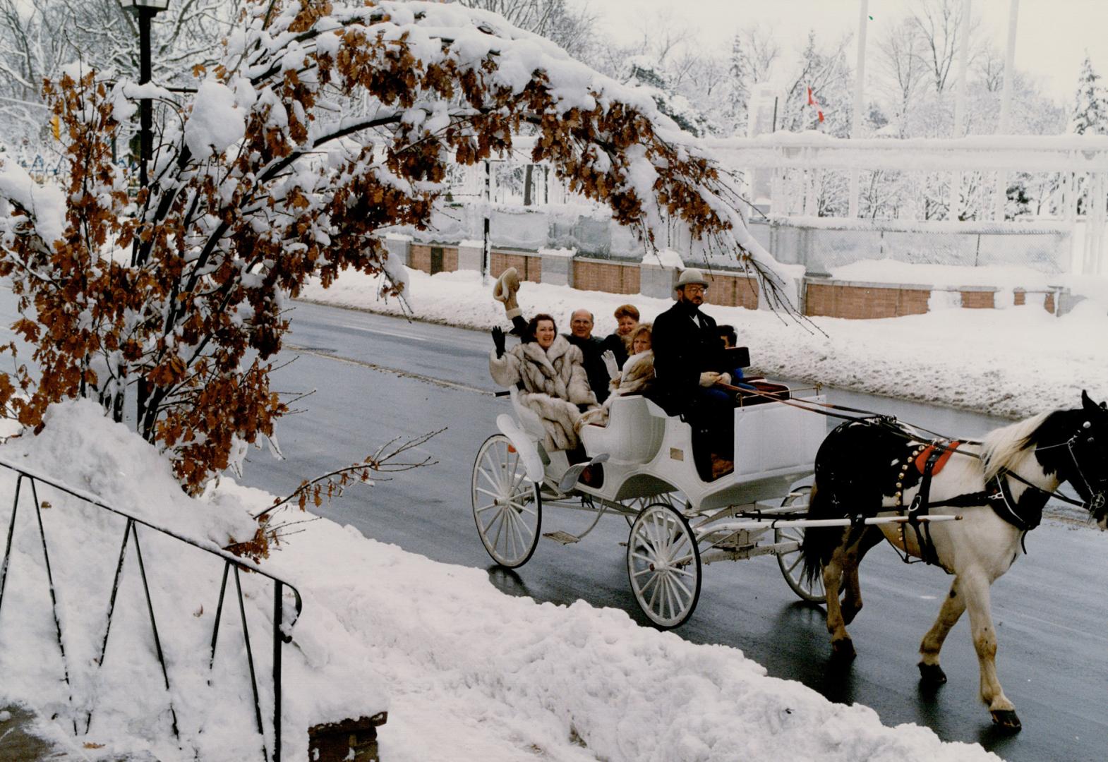 Mayor and merchants: promoting the traditional Christmas in Brampton's Business Improvement Area are Mayor Peter Robertson (waving) and some downtown store owners in a horse-drawn open carriage