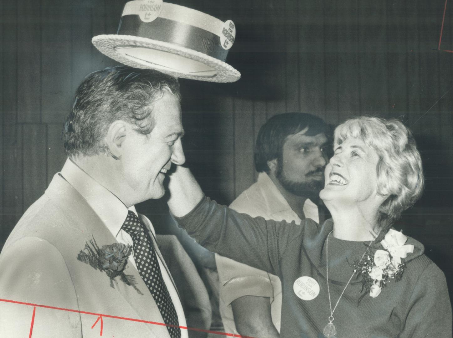 Happy hatter. Liberal Ken Robinson gets the last touch to his Etobicoke South federal election win last night - his wife Margery puts a Grit boater on his head at compaign headquarters