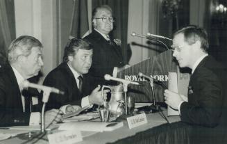 Seated L-R, E. B. McConlley, Clifford Frame, Stephen Roman (at Podium) of Benison Mines Ltd