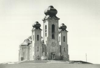 The church that Roman built. The massive Slovak Cathedral of the Transfiguration nears completion on its site beside Romandale Farms, owned by Denison(...)