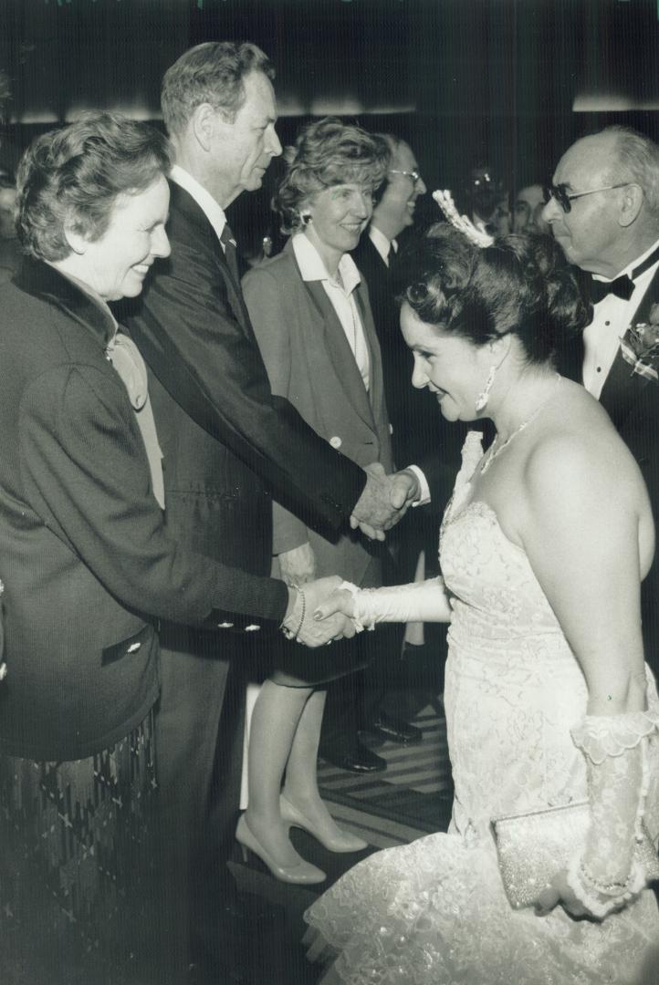 Royal Romanian welcome. Georgette Vujcuf curtsies as she meets Queen Anne of Romania and King Michael at Toronto's Hilton hotel. The royal couple arrived yesterday