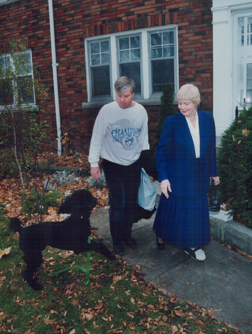 Dawn of a new era: Mayor-elect June Rowlands leaves home this morning with son Murray and pet dog, Lucy, to start the process of taking over the reins of power