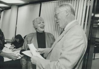 In the running: Toronto mayoral candidate June Rowlands files her nomination papers yesterday with Robert Clark, city director of legislative services