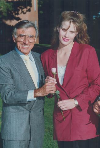 Stars and cars. American actor Jamie Farr and Toronto model actress Monika Schnarre (right) co-star in Black Pearls, a made-in-Toronto movie in which a car was blown up recently on Leslie St