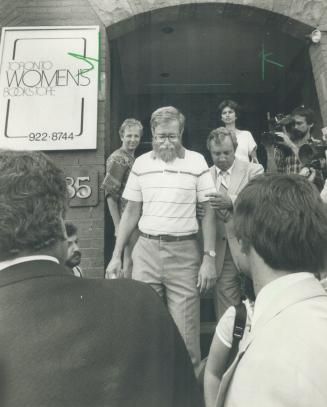 Clinic raided: Dr. Robert Scott (right photo, bearded) is led by a detective from the Harbord St. abortion clinic opened June 15 by Dr. Henry Morgenta(...)