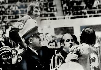 Maple leafs' Eddie Shack (23) stands in penalty box and taunts Steve Durbano of St