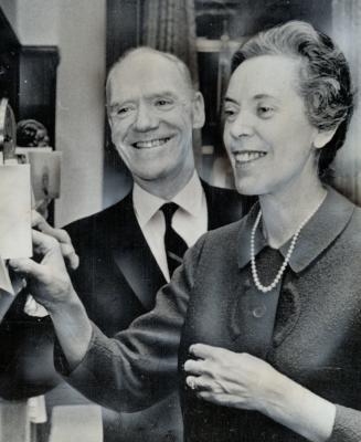 Mr. and Mrs. Mitchell Sharp look at Christmas card collection. They were photographed yesterday in his Ottawa office