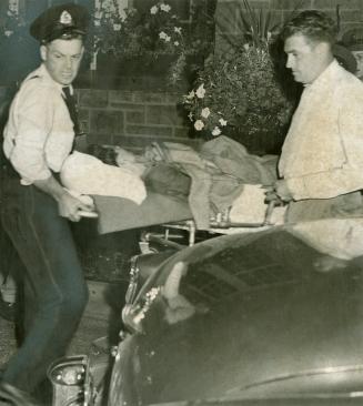 Casualty in unprecedented riot at the Ontario reformatory, Guelph, a prisoner is carried out on a stretcher