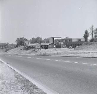 Black and white photograph of present CNIB building on Bayview Avenue, with several wooden stru…