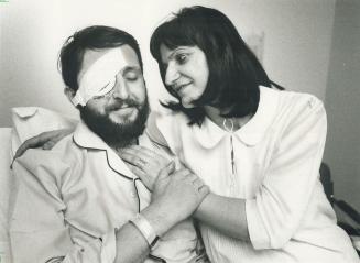 Nightmare attack: Nikola Belchevski is comforted by his wife, Dragica, in hospital where he's recuperating after losing an eye in a fight with an intruder last Sunday.