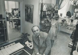 Joseph Bobyk sits in front of a gift boutique in his Avenue Rd. beauty salon which is designed to boost sales and increase service. [Incompelte]